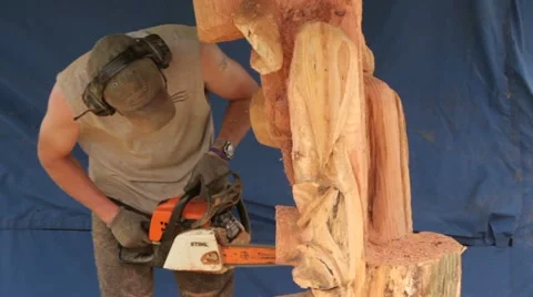 Man carving wood with chain saw Stock Footage
