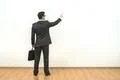 The man with a case gesturing on the white wall background Photo