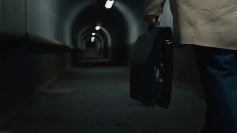 Man with case going through the tunnel Stock Footage 112038511