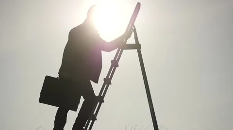 Man with case on ladder going up slow motion against sun Stock Footage 59982437