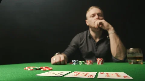 Man in casino doing call with red chips on the green poker table Stock Footage 127384146