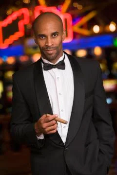 Man in casino smoking cigar (selective focus) Stock Photos
