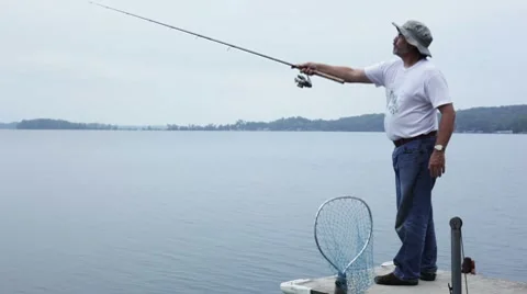 Man casting off a dock and fishing. Video stock 8760149