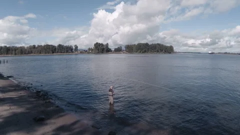 Man casting a fishing line in a large beautiful lake Video stock 153218151