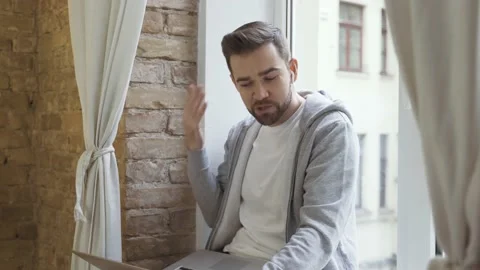 Man in casual clothes using laptop and having video call Video stock 233432489