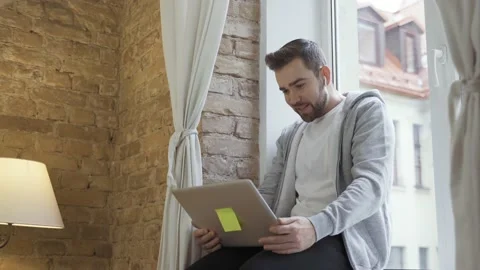 Man in casual clothes using laptop and having video call Video stock 233432636