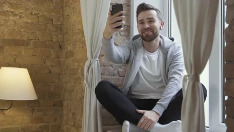Man in casual clothes using phone and having video call Video stock 233433293