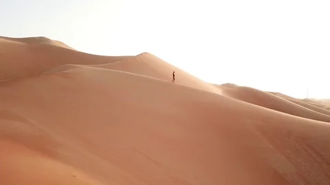 Man in casual clothes walking on sand dunes. Stock Footage