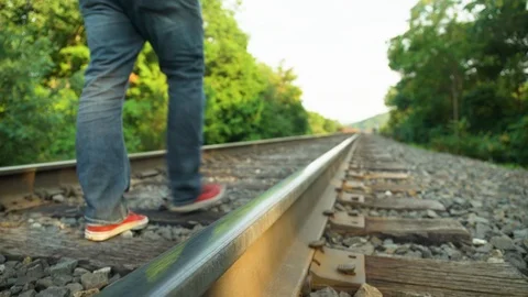 Man casually walks down an old railroad track Video stock 121548762