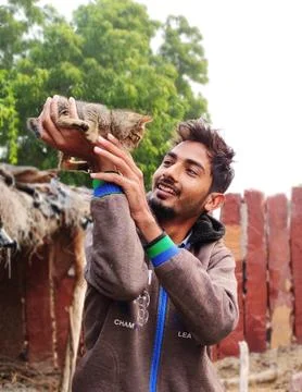 A man catch up to kitten looking face to face  and smiling Stock Photos