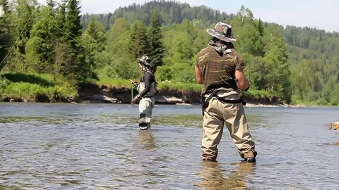Man catches fish in the river. man fishing with a rod and reel. 스톡 동영상 78528260
