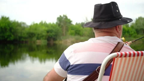 A man catches a predatory fish on the river bank, swamps, on spinning Stock-Footage 135429991