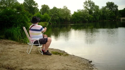 A man catches a predatory fish on the river bank, swamps, on spinning Stock Footage 135430022
