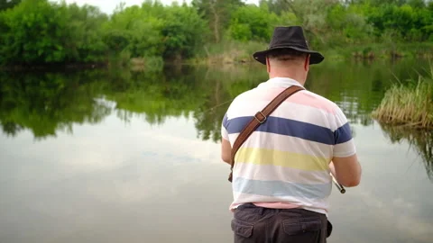 A man catches a predatory fish on the river bank, swamps, on spinning Stock-Footage 135430067