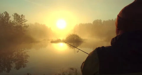 A man is catching fish close-up at sunset Video stock 154930072