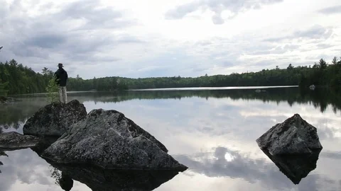 Man Catching a Fish on a Rock Vídeo Stock 79666774