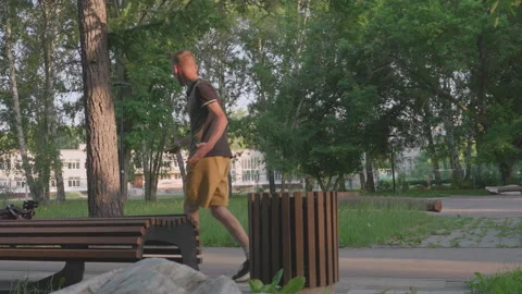 Man Cautiously Watching Park Environment, Observant Individual With Tense Stance Vidéo 329529957