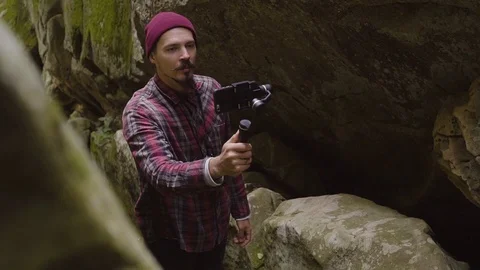 Man in Cave and Rocks Take Video by Phone on the Gimbal, Slow Motion Stock Footage 108617485