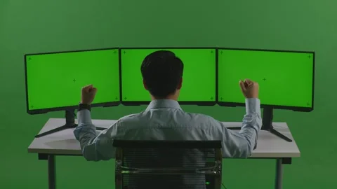 Man Celebrating And Dancing While Working With Mock Up Multiple Computer Monitor Video stock 249624919