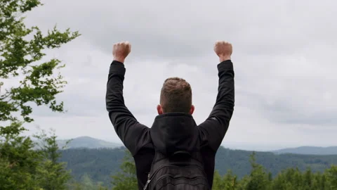 Man celebrating getting to the top of the mountain slow-motion 4K. Video stock 234554853