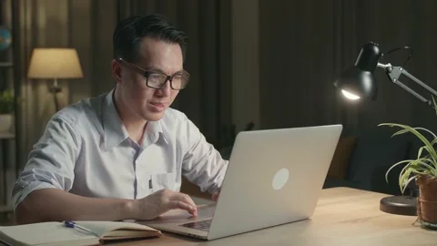 Man Celebrating While Working From Home At Living Room At Night Stock Footage 154917527