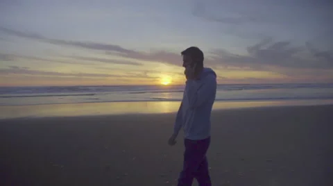 Man on cell phone at the beach Stock Footage 59923096