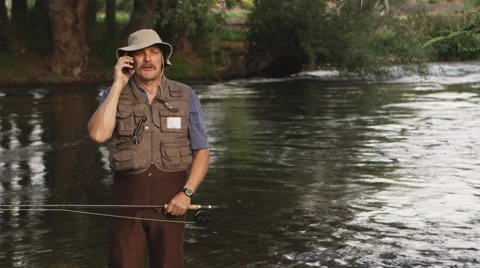 Man on cellphone while fishing Stock-Footage 67350485