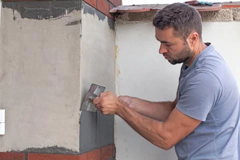 Man cement is applied with a trowel. Stock Photos