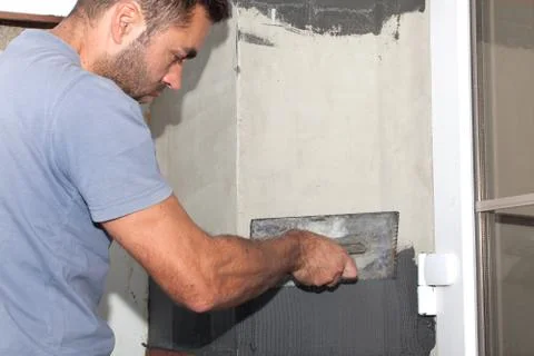Man cement is applied with a trowel. Stock Photos