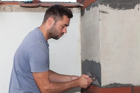 Man cement is applied with a trowel. Stock Photos