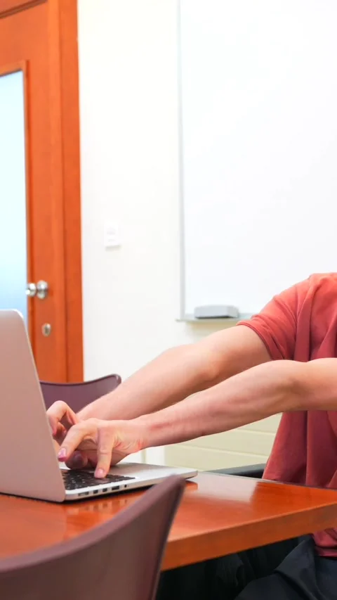 Man with cerebral palsy working using laptop in a coworking Stock Footage 278965042