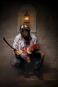 Man chained with blood and knife, has a severed leg blood Stock Photos