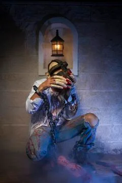 Man chained with blood and knife, has a severed leg blood Stock Photos