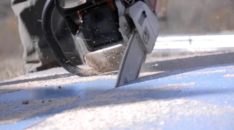 Man with a chainsaw cutting a piece of plywood 09 Stock Footage 59438099