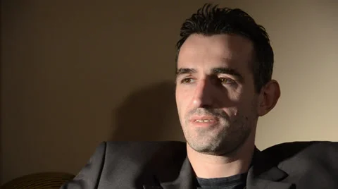 Man in a chair talking Stock Footage 34293107