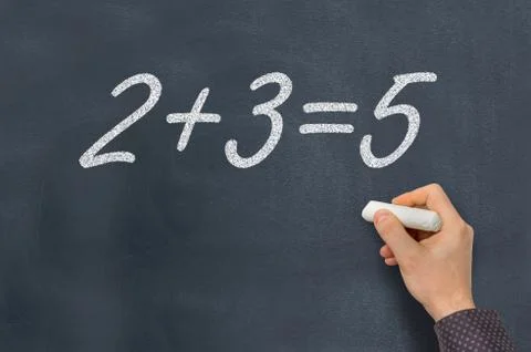 Man with chalk is counting a mathematical task on blackboard - education conc Foto stock