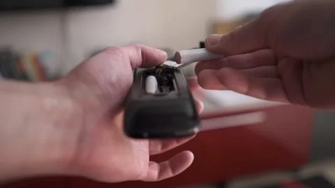 A man changes the batteries in the TV remote control Video stock 267020313