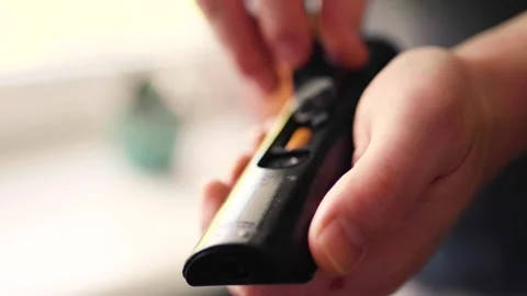 Man changes batteries on a TV remote. Removing remote control battery. Video stock 307907373