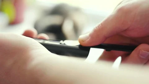 Man changes batteries on a TV remote. Removing remote control battery. Video stock 307907375