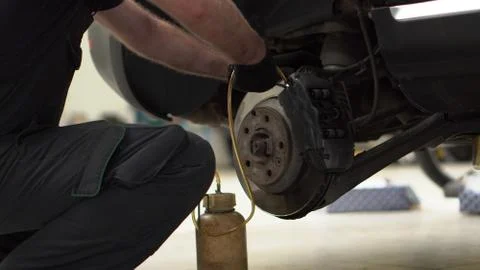 The man changes the brakes Stock Photos