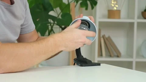 A man changes an electric lamp. Warm yellow light. Replacement an energy-saving Stock Footage 220099749