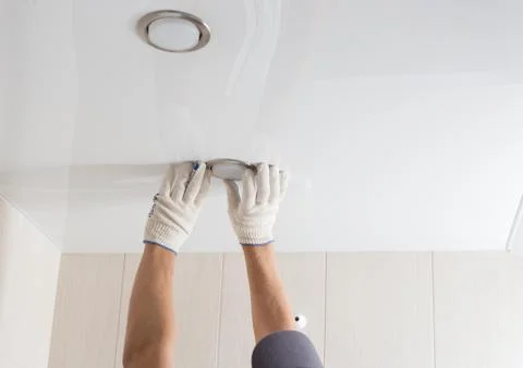 Man changes an electric light bulb, energy efficiency Stock-Fotos