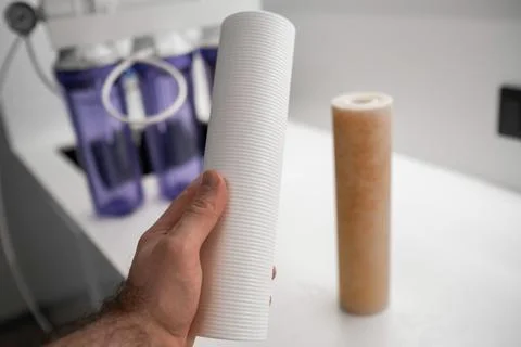 Man changes filters in the system for reversed osmosis Stock Photos