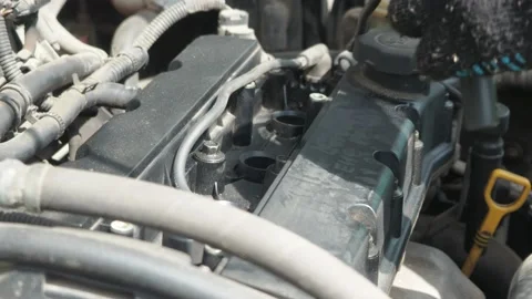 A man changes the high-voltage wires on the car engine. Work under the hood of Stock Footage 158106062