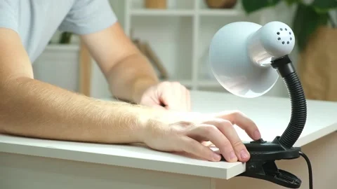 The man changes lamp. Energy-saving lamp. Replacement of an energy-saving lamp. Stock Footage 217511581