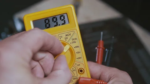 A man changes multimeter knob position to detect malfunctions Stock Footage 156826300