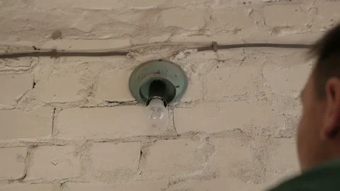 A man changes an ordinary light bulb Stock Footage 89255886