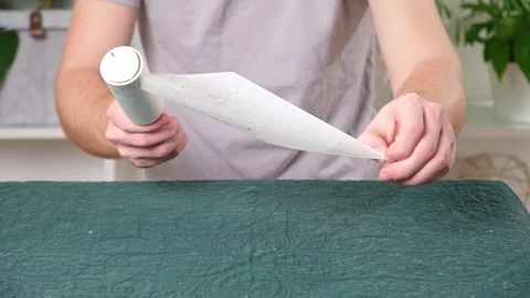 Man changes sticky layer new one clean plaid from hair sticky roller. lint Stock Footage 236922317