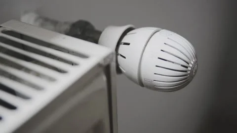 A man changes the temperature. Stock Footage 133317130