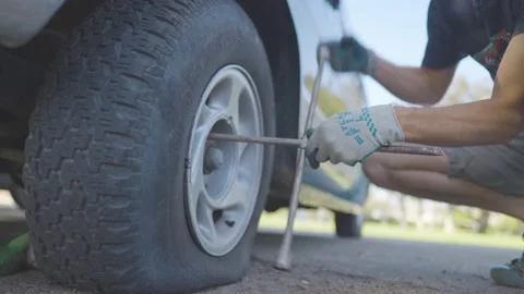 Man Changes Tire - Slow Motion Stock Footage 178333015